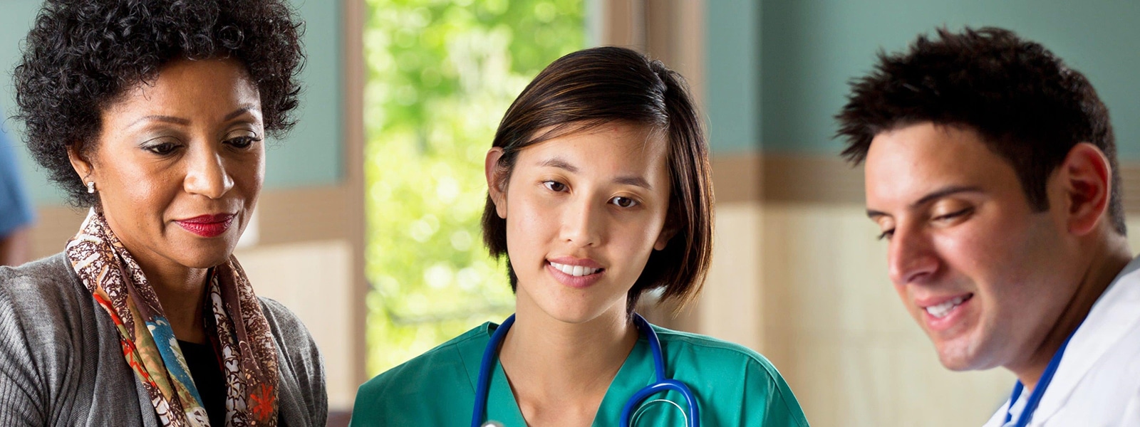 Medical professionals and an administrator review files.